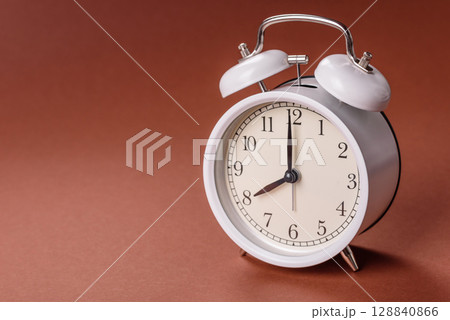 Vintage alarm clock on brown surface as a conceptual background for deadlines for tasks Vintage alarm clock on brown surface as a conceptual background for deadlines for tasks 128840866
