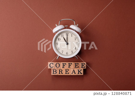 Alarm clock and coffee break lettering as a conceptual backdrop for a work break or meeting 128840871