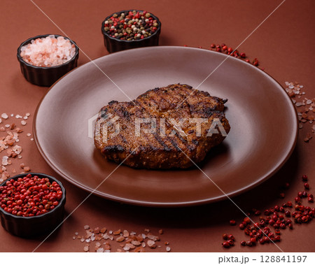 Meat, steak, beef tenderloin cooked on grill. Juicy steak as a food background 128841197