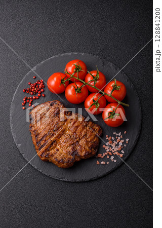 Meat, steak, beef tenderloin cooked on grill. Juicy steak as a food background Meat, steak, beef tenderloin cooked on grill. Juicy steak as a food background 128841200