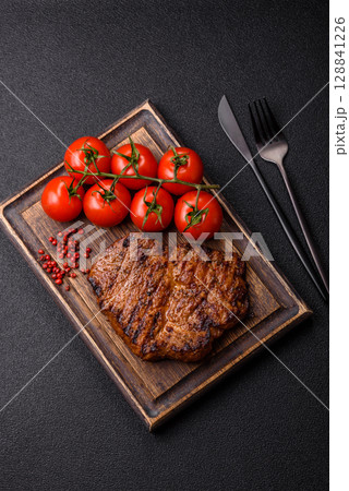 Meat, steak, beef tenderloin cooked on grill. Juicy steak as a food background 128841226