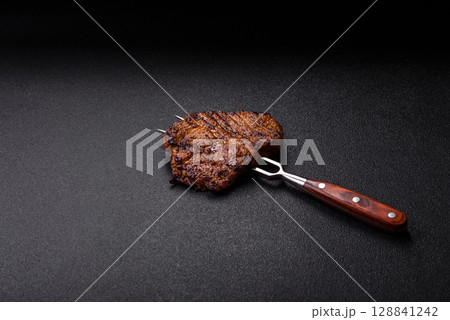 Meat, steak, beef tenderloin cooked on grill. Juicy steak as a food background Meat, steak, beef tenderloin cooked on grill. Juicy steak as a food background 128841242
