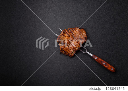 Meat, steak, beef tenderloin cooked on grill. Juicy steak as a food background Meat, steak, beef tenderloin cooked on grill. Juicy steak as a food background 128841243