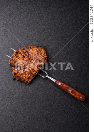 Meat, steak, beef tenderloin cooked on grill. Juicy steak as a food background Meat, steak, beef tenderloin cooked on grill. Juicy steak as a food background 128841244