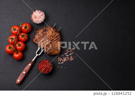 Meat, steak, beef tenderloin cooked on grill. Juicy steak as a food background 128841252