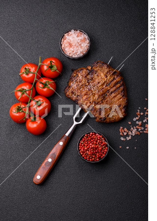 Meat, steak, beef tenderloin cooked on grill. Juicy steak as a food background 128841253