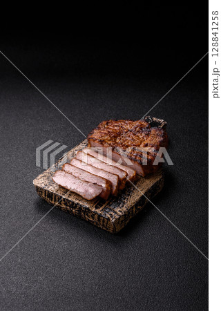 Meat, steak, beef tenderloin cooked on grill. Juicy steak as a food background Meat, steak, beef tenderloin cooked on grill. Juicy steak as a food background 128841258
