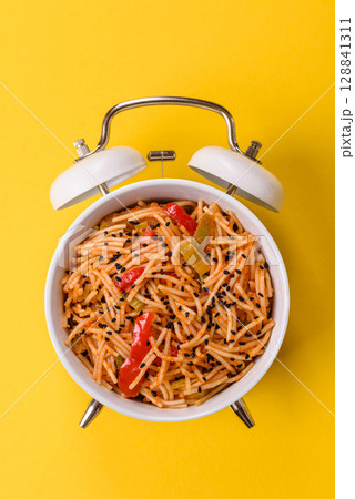 Italian pasta with meat, sauce and vegetables. Conceptual background time to eat pasta Italian pasta with meat, sauce and vegetables. Conceptual background time to eat pasta 128841311