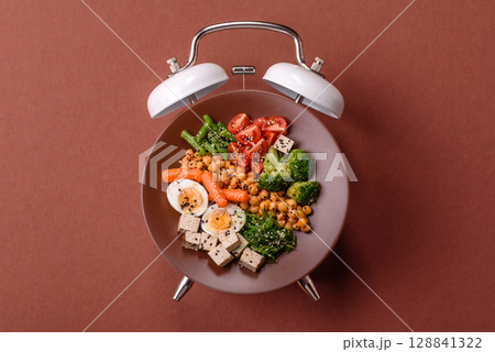 Vegetarian salad with quinoa, vegetables and meat. Conceptual background time to eat vegetarian food 128841322