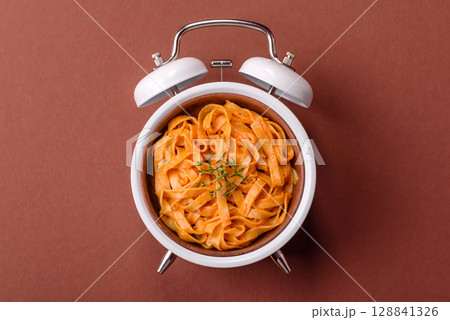 Italian pasta with meat, sauce and vegetables. Conceptual background time to eat pasta 128841326