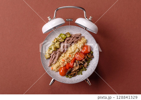 Vegetarian salad with quinoa, vegetables and meat. Conceptual background time to eat vegetarian food 128841329