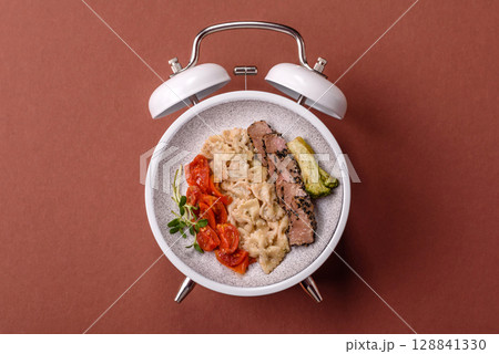 Italian pasta with meat, sauce and vegetables. Conceptual background time to eat pasta Italian pasta with meat, sauce and vegetables. Conceptual background time to eat pasta 128841330