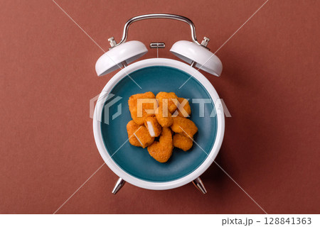 Chicken nuggets, crispy fried food with sauce. Fast food concept Chicken nuggets, crispy fried food with sauce. Fast food concept 128841363