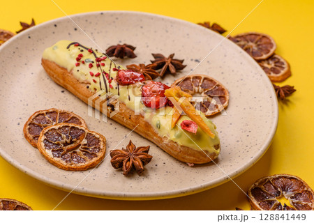 French food, dessert eclair with chocolate filling. Eclair as a background 128841449