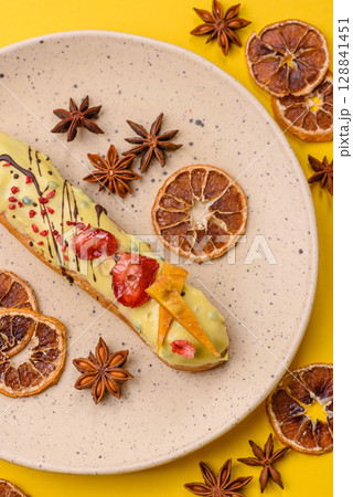 French food, dessert eclair with chocolate filling. Eclair as a background French food, dessert eclair with chocolate filling. Eclair as a background 128841451