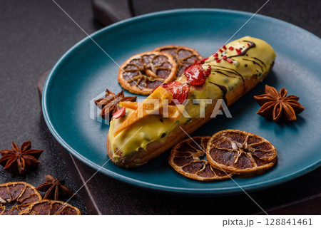 French food, dessert eclair with chocolate filling. Eclair as a background French food, dessert eclair with chocolate filling. Eclair as a background 128841461