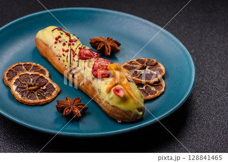 French food, dessert eclair with chocolate filling. Eclair as a background French food, dessert eclair with chocolate filling. Eclair as a background 128841465