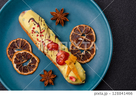 French food, dessert eclair with chocolate filling. Eclair as a background 128841466