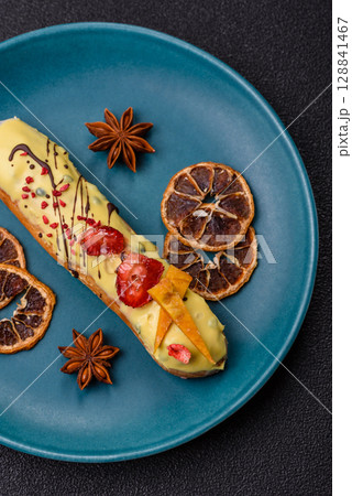 French food, dessert eclair with chocolate filling. Eclair as a background 128841467