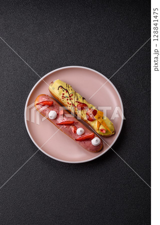 French food, dessert eclair with chocolate filling. Eclair as a background 128841475