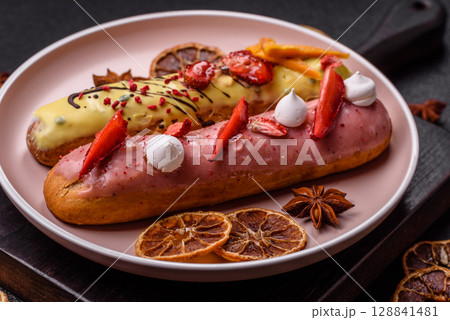 French food, dessert eclair with chocolate filling. Eclair as a background French food, dessert eclair with chocolate filling. Eclair as a background 128841481
