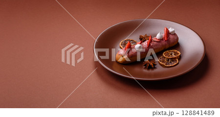 French food, dessert eclair with chocolate filling. Eclair as a background French food, dessert eclair with chocolate filling. Eclair as a background 128841489