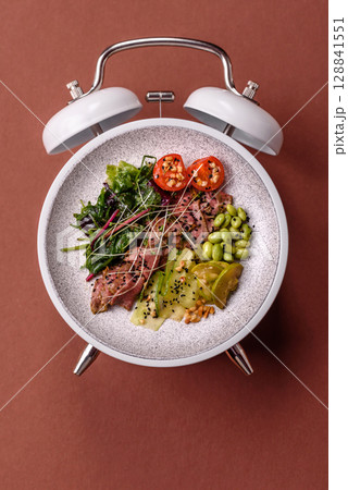 Salad with chicken, tomatoes and eggs with seeds and grains. Concept time to eat dinner 128841551