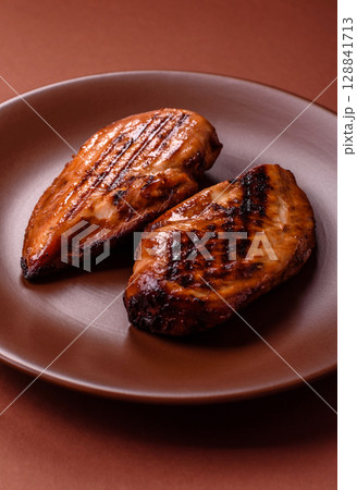 Chicken breast, grilled fillet, meat meal on a plate. Grilled poultry for dinner Chicken breast, grilled fillet, meat meal on a plate. Grilled poultry for dinner 128841713