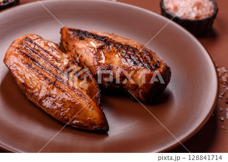 Chicken breast, grilled fillet, meat meal on a plate. Grilled poultry for dinner Chicken breast, grilled fillet, meat meal on a plate. Grilled poultry for dinner 128841714