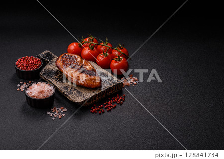 Chicken breast, grilled fillet, meat meal on a plate. Grilled poultry for dinner Chicken breast, grilled fillet, meat meal on a plate. Grilled poultry for dinner 128841734