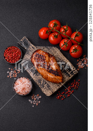 Chicken breast, grilled fillet, meat meal on a plate. Grilled poultry for dinner Chicken breast, grilled fillet, meat meal on a plate. Grilled poultry for dinner 128841736