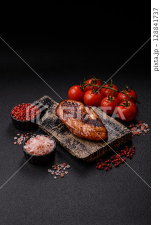 Chicken breast, grilled fillet, meat meal on a plate. Grilled poultry for dinner Chicken breast, grilled fillet, meat meal on a plate. Grilled poultry for dinner 128841737