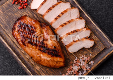 Chicken breast, grilled fillet, meat meal on a plate. Grilled poultry for dinner Chicken breast, grilled fillet, meat meal on a plate. Grilled poultry for dinner 128841761