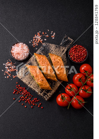 Roll of omelette, spinach, cheese and minced meat 128841769