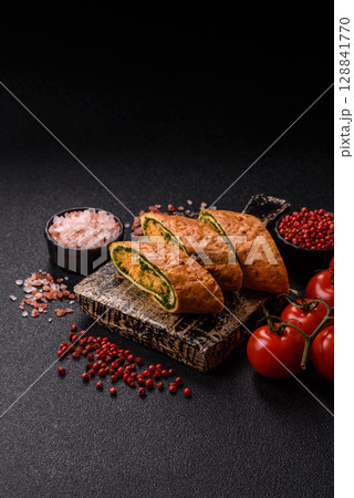 Roll of omelette, spinach, cheese and minced meat Roll of omelette, spinach, cheese and minced meat 128841770