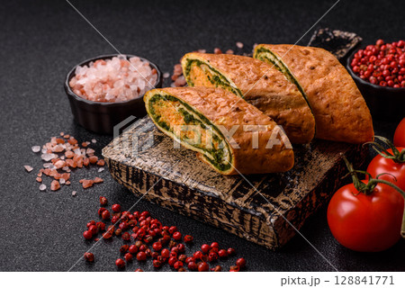 Roll of omelette, spinach, cheese and minced meat 128841771