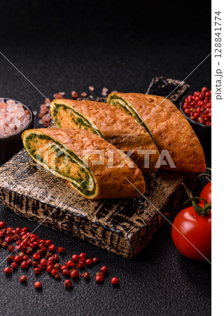 Roll of omelette, spinach, cheese and minced meat Roll of omelette, spinach, cheese and minced meat 128841774