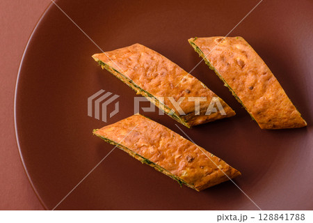 Roll of omelette, spinach, cheese and minced meat 128841788