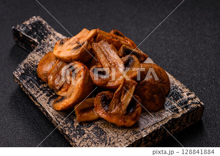 Food, baked mushrooms champignon slices with sauce and spices 128841884