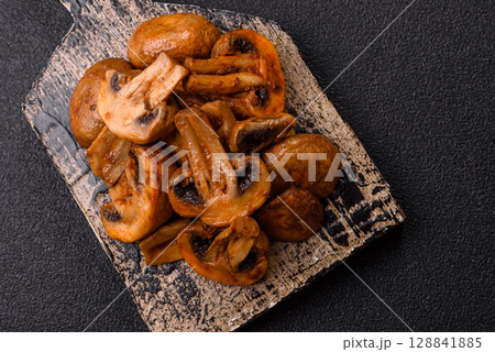 Food, baked mushrooms champignon slices with sauce and spices Food, baked mushrooms champignon slices with sauce and spices 128841885