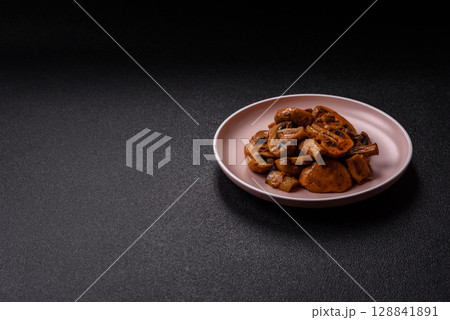 Food, baked mushrooms champignon slices with sauce and spices Food, baked mushrooms champignon slices with sauce and spices 128841891