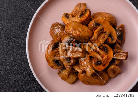 Food, baked mushrooms champignon slices with sauce and spices 128841895