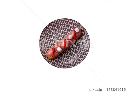 French food, dessert eclair with chocolate filling. Eclair as a background French food, dessert eclair with chocolate filling. Eclair as a background 128841916