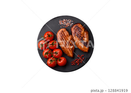Chicken breast, grilled fillet, meat meal on a plate. Grilled poultry for dinner 128841919