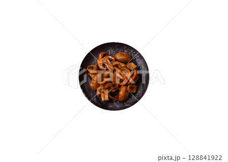 Food, baked mushrooms champignon slices with sauce and spices 128841922