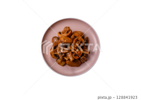 Food, baked mushrooms champignon slices with sauce and spices 128841923