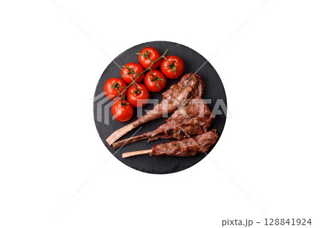 Juicy meat on the bone or rack of lamb. Grilled veal with salt, spices and herbs Juicy meat on the bone or rack of lamb. Grilled veal with salt, spices and herbs 128841924