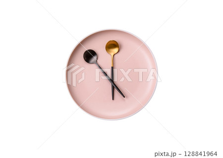 Empty plate with devices in the form of clock hands as a conceptual background for lunch time 128841964