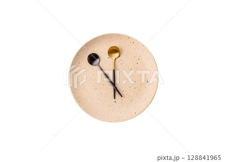 Empty plate with devices in the form of clock hands as a conceptual background for lunch time Empty plate with devices in the form of clock hands as a conceptual background for lunch time 128841965