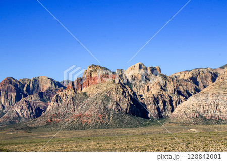 Red Rock Mountains Under Clear Blue Sky in Desert Landscape Red Rock Mountains Under Clear Blue Sky in Desert Landscape 128842001